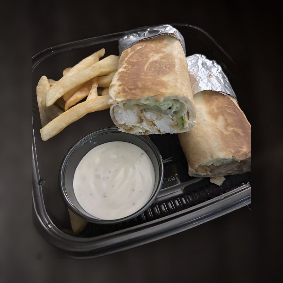 Breaded chicken wrap cut in half, with fries and ranch