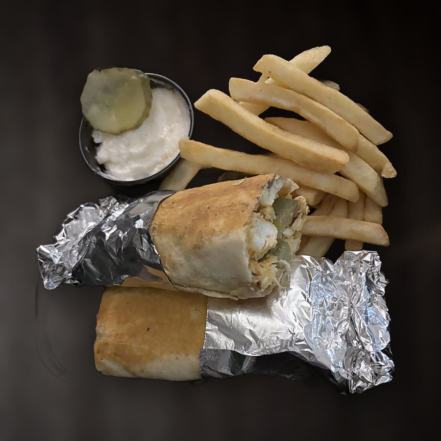 Chicken shawarma wrap cut in half, with fries and garlic sauce
